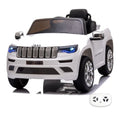 Jeep Grand Cherokee blanche, voiture électrique enfant 12V, vue trois quarts avant avec sa télécommande